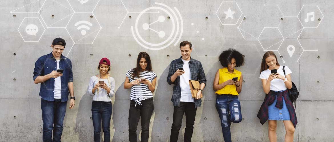 Photo représentant différentes personnes utilisant leur smartphone, illustrant le fait que le marketing digital permet de toucher un public en ligne beaucoup plus large que ce que permet la publicité traditionnelle.