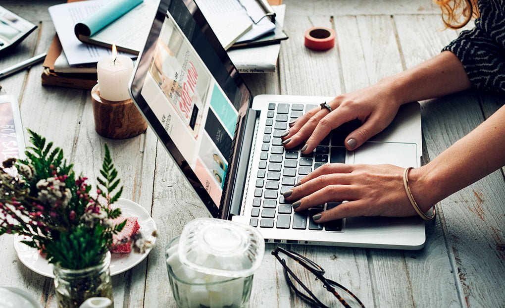 Photo représentant une internaute sur son ordinateur portable et illustrant la nécessité pour un site web de proposer du contenu pertinent pour susciter de l'engagement